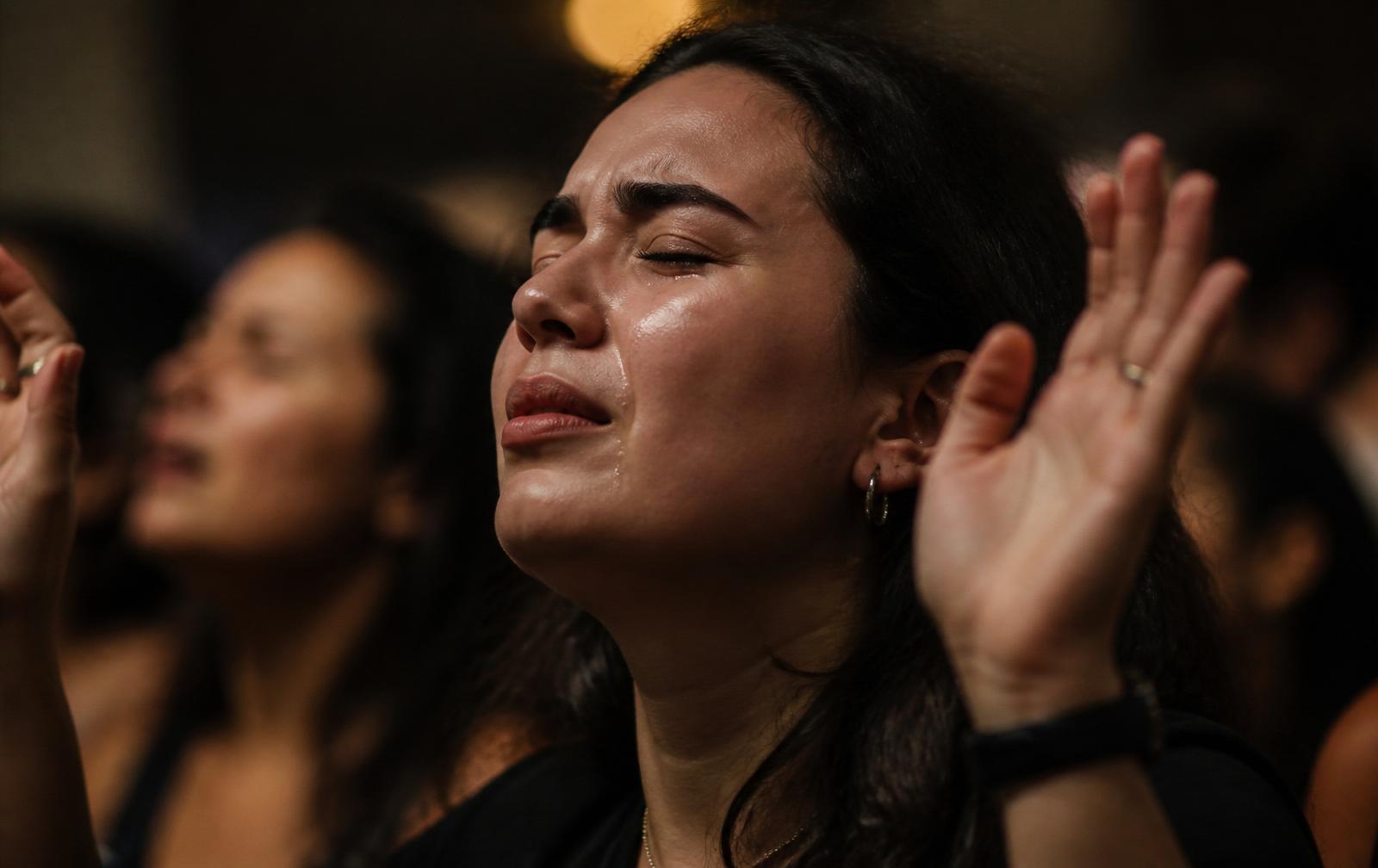 Woman worshiping in tears